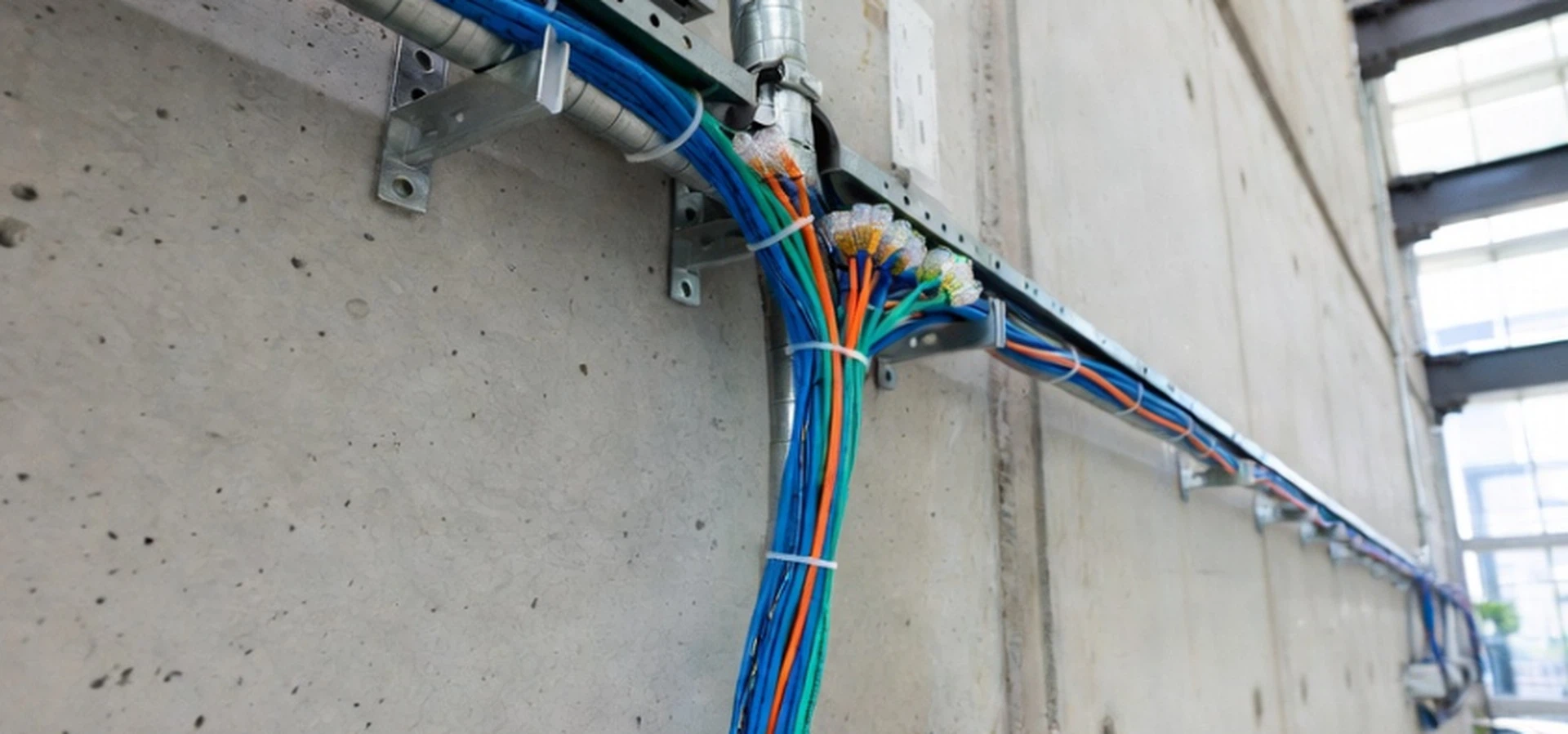Commercial building structured cabling installation showing bundled Cat6a ethernet cables in conduit, highlighting thermal management for high-power PoE wireless APs Commercial building structured cabling installation showing bundled Cat6a ethernet cables in conduit, highlighting thermal management for high-power PoE wireless APs